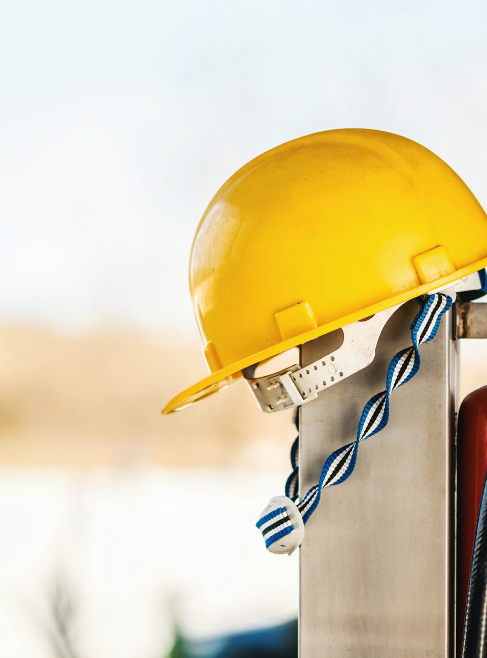 Fire extinguisher and a protective helmet close up photo.