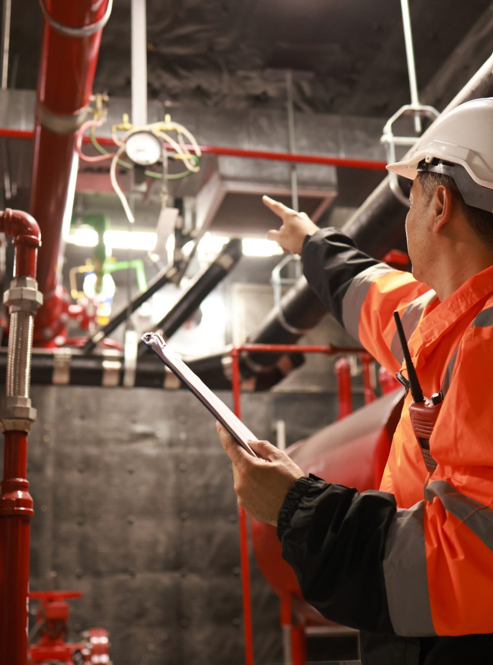 The engineer inspects the safety equipment on the fire extinguishing system.